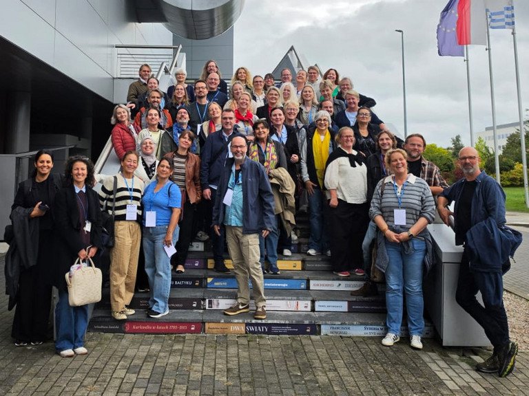 Group picture: The participants of the ETEN Meeting standing on stairs