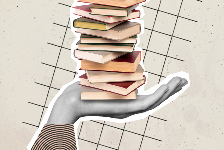 Eine Hand hält einen Stapel Bücher.